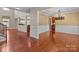Open-concept living room featuring hardwood floors, white trim, and an elegant chandelier at 126 Northbridge Dr, Mooresville, NC 28115