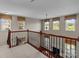 Loft area with railings overlooking the living room with natural light at 126 Northbridge Dr, Mooresville, NC 28115