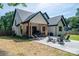 Inviting backyard with covered patio, stone fire pit, and comfortable lounge seating at 140 Robin Rd, Lincolnton, NC 28092