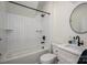 Modern bathroom featuring sleek fixtures, a shower-tub combo with tiled walls, and a round mirror at 140 Robin Rd, Lincolnton, NC 28092