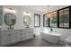 Spa-like bathroom featuring a freestanding tub, black fixtures, and a double vanity at 140 Robin Rd, Lincolnton, NC 28092