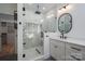 This luxurious bathroom boasts marble tile, black fixtures, and a glass shower with a rainfall showerhead at 140 Robin Rd, Lincolnton, NC 28092