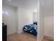 Teen bedroom with hardwood floors, a bed with blue bedding, and a decorative neon light at 140 Robin Rd, Lincolnton, NC 28092