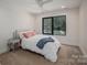 Cozy bedroom with a soft white bed, pink pillows, and natural light from the window at 140 Robin Rd, Lincolnton, NC 28092