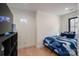Bedroom with hardwood floors, blue camo bedding, neon controller light, and a modern storage shelf at 140 Robin Rd, Lincolnton, NC 28092