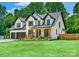 Beautiful white two-story home with black trim, manicured lawn, and colorful flowerbeds at 140 Robin Rd, Lincolnton, NC 28092