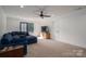 Spacious living room featuring comfortable seating, a ceiling fan, and natural light, creating a welcoming atmosphere at 140 Robin Rd, Lincolnton, NC 28092