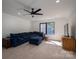 Comfortable living room with a plush blue sectional sofa, natural light, and a ceiling fan at 140 Robin Rd, Lincolnton, NC 28092