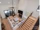 Bright living room showcasing a fireplace, high ceilings, modern staircase, and a comfortable seating area at 140 Robin Rd, Lincolnton, NC 28092