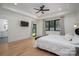 Spacious main bedroom with black window frames, tray ceiling, hardwood floors, and access to the backyard at 140 Robin Rd, Lincolnton, NC 28092