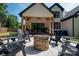 Covered patio with stone fire pit, plenty of seating and backyard views at 140 Robin Rd, Lincolnton, NC 28092