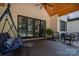 Spacious covered patio with outdoor seating, swing, and view of the landscaped backyard at 140 Robin Rd, Lincolnton, NC 28092