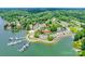 Aerial view showcasing waterfront condos with boat docks, a lakeside community, and scenic water views at 14053 Queens Harbor Rd, Charlotte, NC 28278