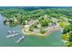Aerial view showcases a waterfront community with boat docks, lush greenery, and serene lakeside living at 14053 Queens Harbor Rd, Charlotte, NC 28278