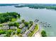 Aerial view features a waterfront community with boat docks, lush greenery, and serene lakeside living at 14053 Queens Harbor Rd, Charlotte, NC 28278