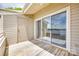 Balcony featuring sliding glass doors, a wooden deck, and scenic lake views for relaxation and outdoor enjoyment at 14053 Queens Harbor Rd, Charlotte, NC 28278