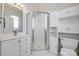 Bathroom with a shower, large mirror, and bright lighting at 14053 Queens Harbor Rd, Charlotte, NC 28278