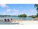 Private beach access with chairs overlooking the serene lake and boat dock at 14053 Queens Harbor Rd, Charlotte, NC 28278
