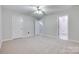 Neutral bedroom boasts a ceiling fan, carpet, and two doors, creating a serene, comfortable atmosphere at 14053 Queens Harbor Rd, Charlotte, NC 28278