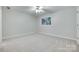 Bright bedroom features a ceiling fan, carpet, and a window, creating a serene, comfortable atmosphere at 14053 Queens Harbor Rd, Charlotte, NC 28278