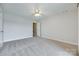 Bedroom with neutral walls, plush carpeting, and a ceiling fan at 14053 Queens Harbor Rd, Charlotte, NC 28278