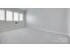 Large bedroom with neutral carpet, large window and natural light at 14053 Queens Harbor Rd, Charlotte, NC 28278