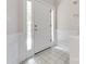 Tiled foyer with a white front door and sidelights, showcasing a bright and welcoming entrance at 14053 Queens Harbor Rd, Charlotte, NC 28278