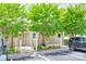 Charming condo exterior with lush trees, a sidewalk, and reserved parking, offering a welcoming curb appeal at 14053 Queens Harbor Rd, Charlotte, NC 28278