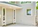 Inviting front entrance featuring a beige door with glass sidelights and a covered porch at 14053 Queens Harbor Rd, Charlotte, NC 28278
