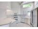 Bright kitchen features white appliances and cabinets, with ample counter space, ideal for cooking and entertaining at 14053 Queens Harbor Rd, Charlotte, NC 28278