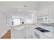 Bright kitchen featuring white cabinetry and appliances and an open layout to living spaces at 14053 Queens Harbor Rd, Charlotte, NC 28278