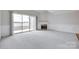 Bright living room with a fireplace and sliding door access to a patio at 14053 Queens Harbor Rd, Charlotte, NC 28278