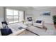 Bright living room featuring a fireplace, stylish furniture, and sliding doors that offer serene water views at 14053 Queens Harbor Rd, Charlotte, NC 28278
