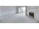 Spacious living room featuring carpeting, a fireplace, and a sliding glass door to the outside at 14053 Queens Harbor Rd, Charlotte, NC 28278