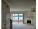 Carpeted Living room with lake view, fireplace, and deck access at 14053 Queens Harbor Rd, Charlotte, NC 28278