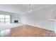Spacious living room with hardwood floors and fireplace, offering a cozy ambiance and scenic lake views at 14053 Queens Harbor Rd, Charlotte, NC 28278