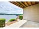 Enjoy this condo's covered outdoor patio with lake views, perfect for relaxing or entertaining guests by the water at 14053 Queens Harbor Rd, Charlotte, NC 28278