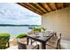 Charming patio with a dining table overlooking the lake, perfect for enjoying meals with a scenic view at 14053 Queens Harbor Rd, Charlotte, NC 28278