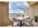 Charming patio with a dining table overlooking the lake, ideal for enjoying meals with scenic views at 14053 Queens Harbor Rd, Charlotte, NC 28278