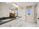 Bathroom with double sinks, white marble floor, and glass enclosed shower at 15906 Parkside Crossing Dr # 317, Charlotte, NC 28273