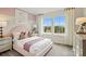 Bright bedroom featuring a pastel pink palette, two windows with a scenic view, and stylish decor at 15906 Parkside Crossing Dr # 317, Charlotte, NC 28273