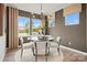 Inviting dining area with a round table, stylish chairs, and natural light from large windows at 15906 Parkside Crossing Dr # 317, Charlotte, NC 28273