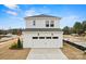 Two-car garage with white doors and an expansive driveway, offering ample parking at 15906 Parkside Crossing Dr # 317, Charlotte, NC 28273