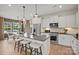 Well-appointed kitchen with a gray island, white cabinets, and stainless steel appliances at 15906 Parkside Crossing Dr # 317, Charlotte, NC 28273