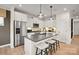 Modern kitchen featuring stainless steel appliances, a center island with seating, and sleek cabinetry at 15906 Parkside Crossing Dr # 317, Charlotte, NC 28273