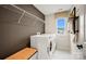 Laundry room with white washer/dryer set, dark wall, and shelving at 15906 Parkside Crossing Dr # 317, Charlotte, NC 28273