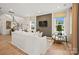 Spacious living room with large windows, modern lighting, and a decorative accent wall at 15906 Parkside Crossing Dr # 317, Charlotte, NC 28273