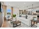 Bright living room with stylish decor, including a plush sofa, accent chair, and hardwood floors at 15906 Parkside Crossing Dr # 317, Charlotte, NC 28273