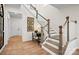 Elegant staircase with wood and white railings, leading to the upper level at 15906 Parkside Crossing Dr # 317, Charlotte, NC 28273