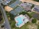 Aerial view showcasing community tennis courts, pool, clubhouse, and neighborhood at 16112 Langston Dr, Charlotte, NC 28278